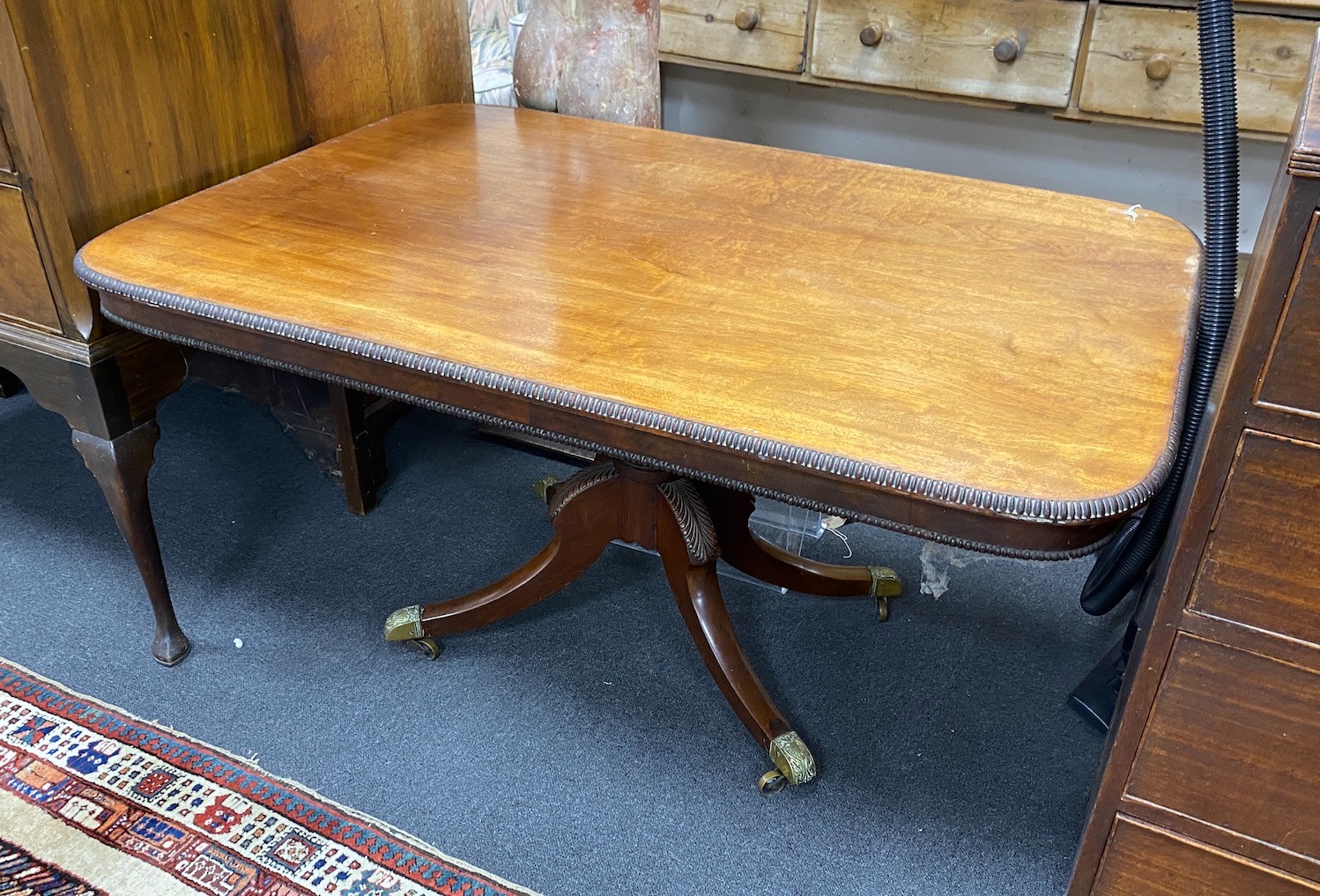 A Regency rectangular mahogany tilt top dining table, length 136cm, width 94cm, height 71cm